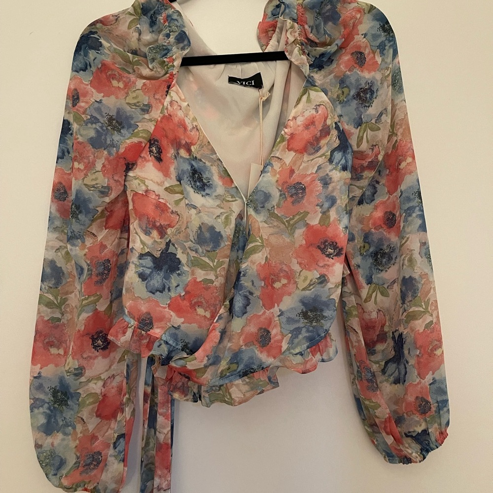 Vici long sleeve floral wrap top. NWT
